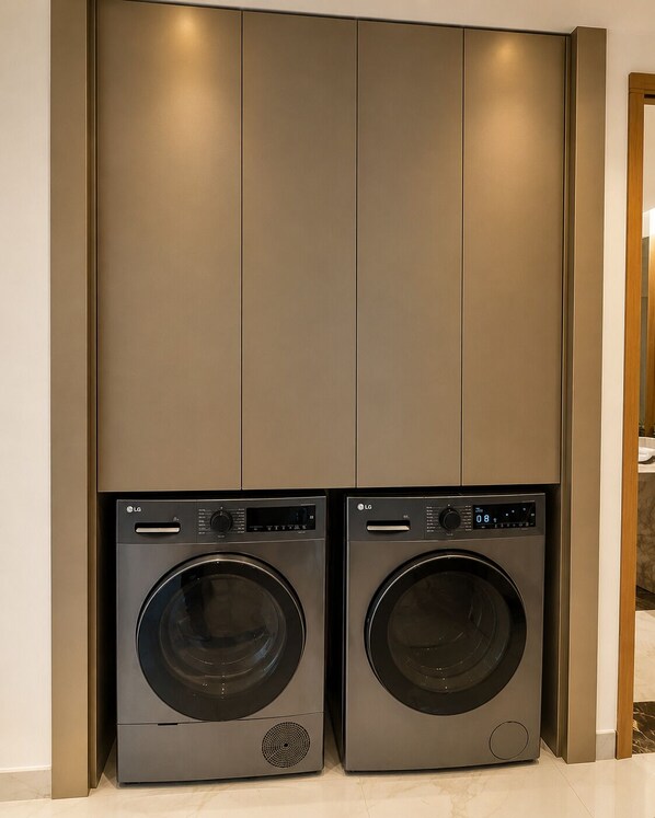 A modern laundry room with two LG front-loading washing machines.