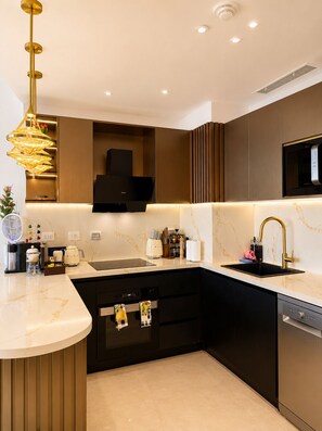 A modern kitchen with a built-in stove, a sink, and a dishwasher.