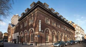 A historic building with arched windows and a sign reading 'BRATHS.' - St. Lukes View, Old Street, by the Design Traveller (Greater London)