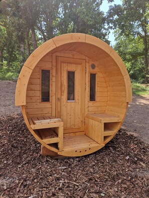 A wooden sauna with a door, two windows, and a bench. - "LSN6" Chalet: Cozy & High-End Comfort with Sauna, Spa, Air Conditioning, Foosball, and Pool (Anould)