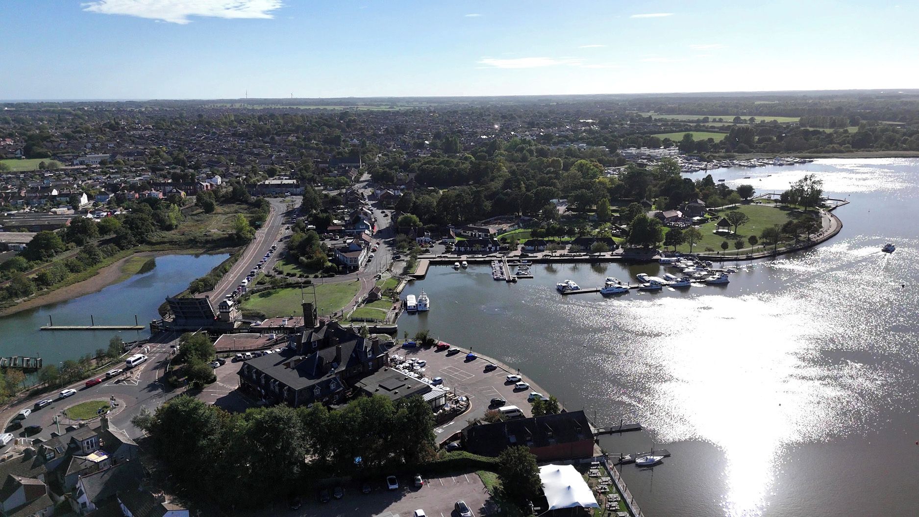 A riverside town with a marina, a prominent church, and residential areas.