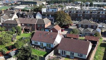 A residential area with houses, a marina, and a clear sky.