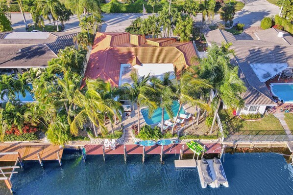 An aerial view of a resort with a swimming pool, boat dock, and palm trees. - Waterfront With Pool Spa Tiki Bar and 1 Mile to Beach (Fort Lauderdale)