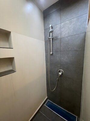 A shower with a handheld showerhead and a wall-mounted faucet. - Vacation Home 'Atlantic Dream' with Sea View, Private Terrace and Wi-Fi (Costa Calma)