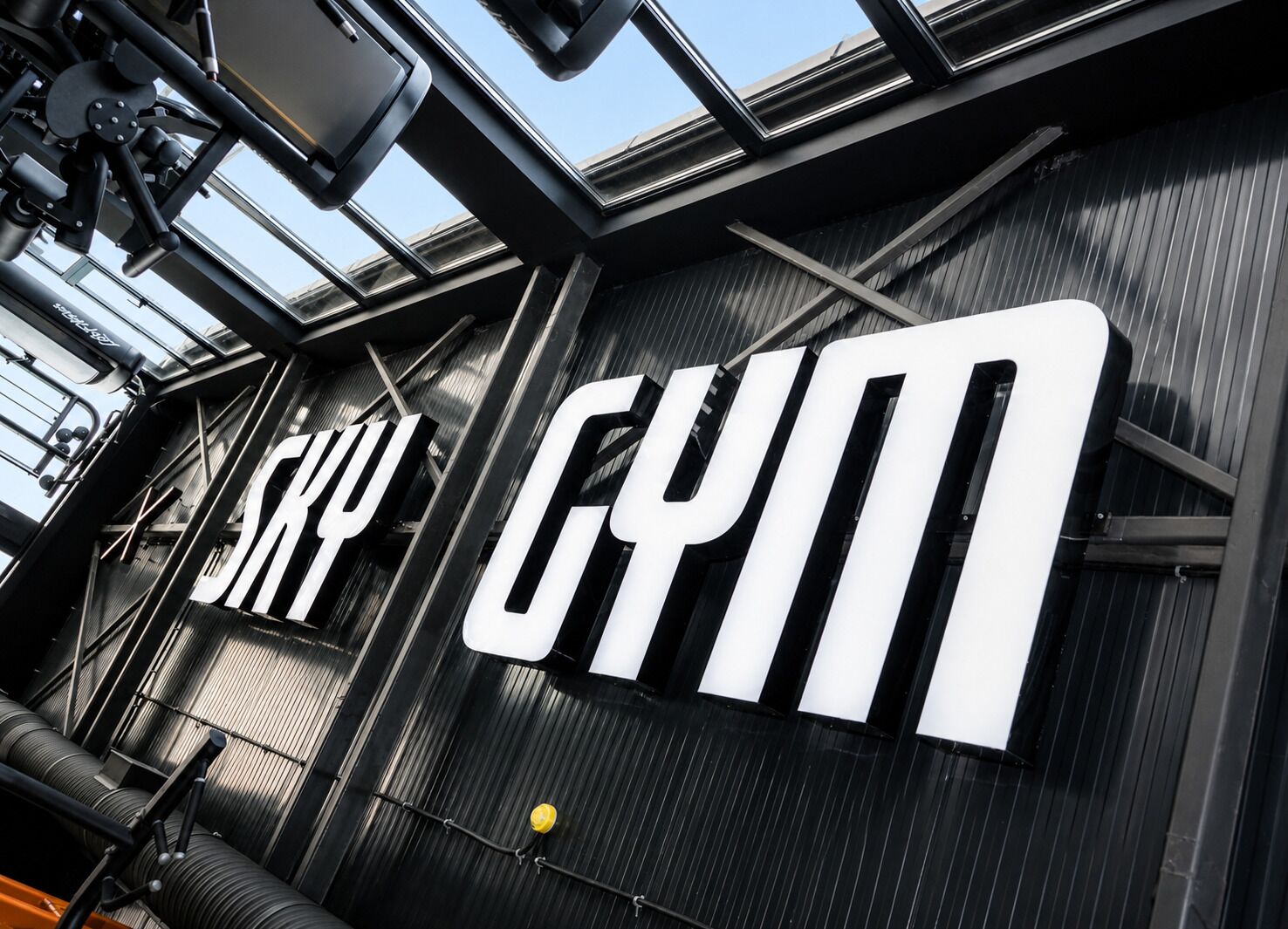 A gym with a large 'SKY GYM' sign on the wall.