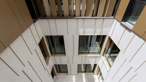 A modern building with a geometric facade, multiple windows, and a tiled floor. -  Genteel Home Solanilla  (Valladolid)