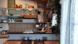 Una cocina con armarios de madera, una isla central y dos sillas de madera.