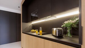 A modern kitchen with a built-in microwave, toaster, and a small sink. - Spectacular Apartment in Valladolid Center Solanilla III (Valladolid)