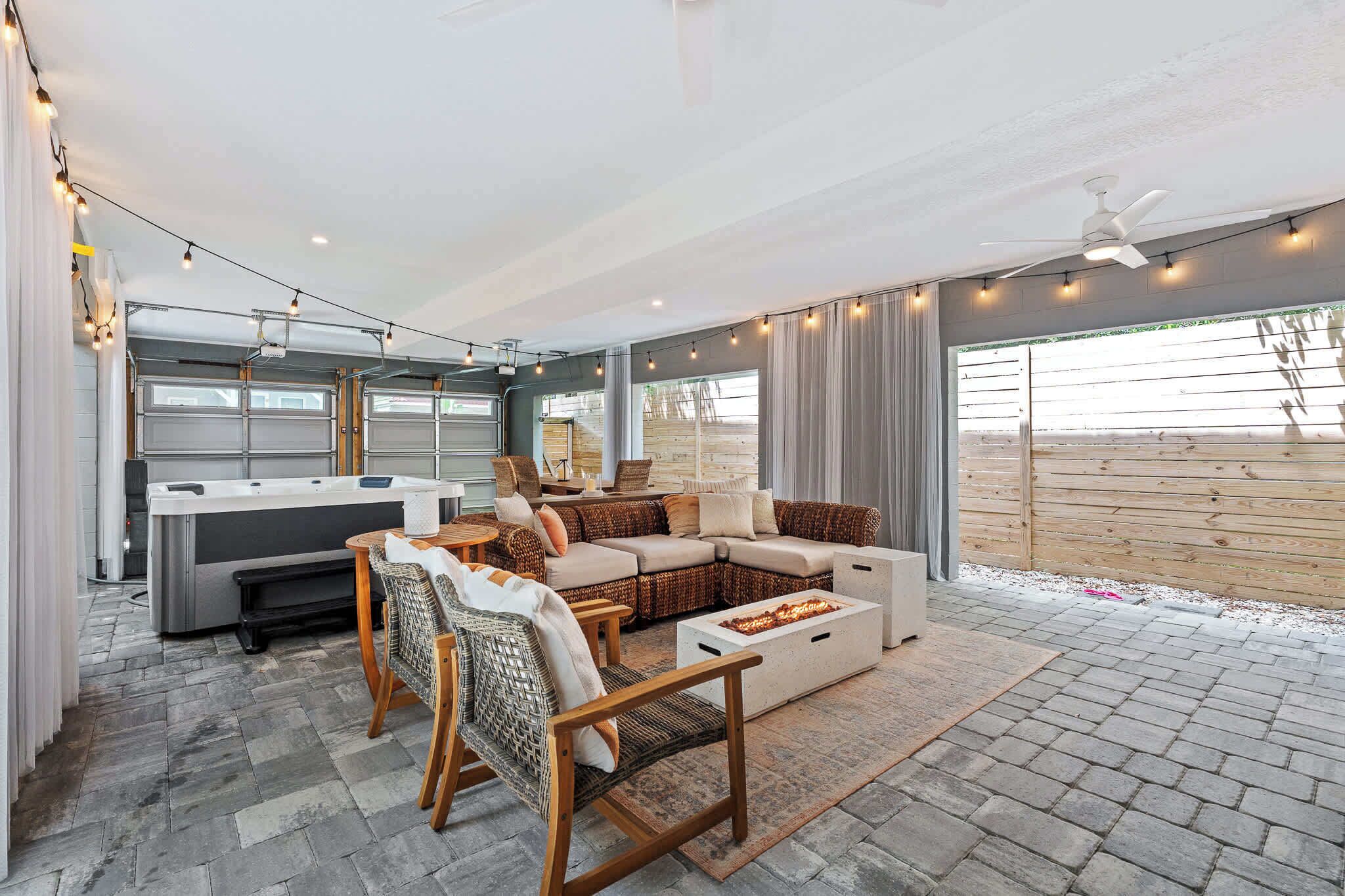 A cozy living area with a sofa, chairs, and a fire pit.