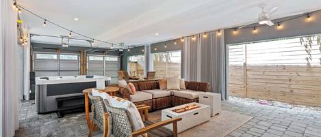 A cozy living area with a sofa, chairs, and a fire pit.
