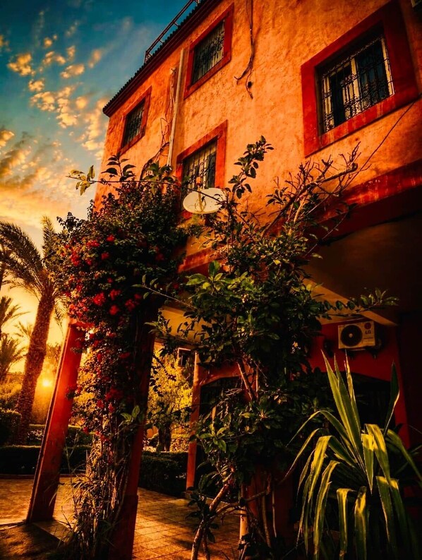 A building with multiple windows and a satellite dish. - Lina Stay Riads, an authentic family-run riad in the center (Marrakesh)