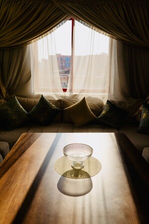A room with a sofa, a table with a glass bowl, and sheer curtains. - A Luxurious, Modern, Central Gem + Netflix (Marrakesh)