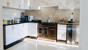 A modern kitchen with white cabinets, a stainless steel range, and a dishwasher. - A Luxurious, Modern, Central Gem + Netflix (Marrakesh)