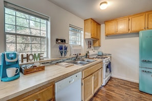 A kitchen with a dishwasher, stove, sink, and a refrigerator. - Family-friendly 'forest Cabin' w/ Hot Tub (Applegate)