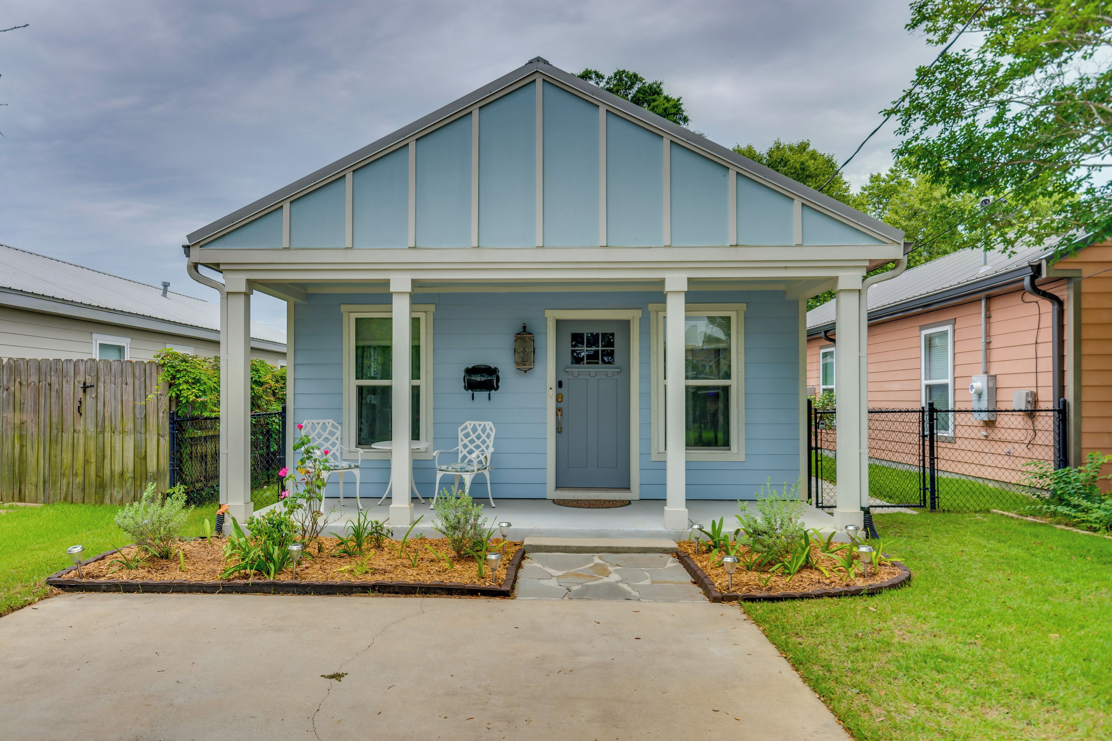 A single-story house with a porch, a front door, and a mailbox.