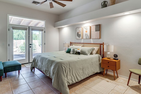 A bedroom with a bed, bedside tables, a bench, and a ceiling fan. - Saguaro Sanctuary: Tucson Home w/ Outdoor Oasis (Tucson)