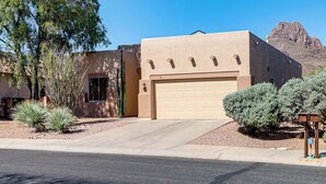 A modern two-story house with a garage, surrounded by desert vegetation and a mountain in the background. - Saguaro Sanctuary: Tucson Home w/ Outdoor Oasis (Tucson)