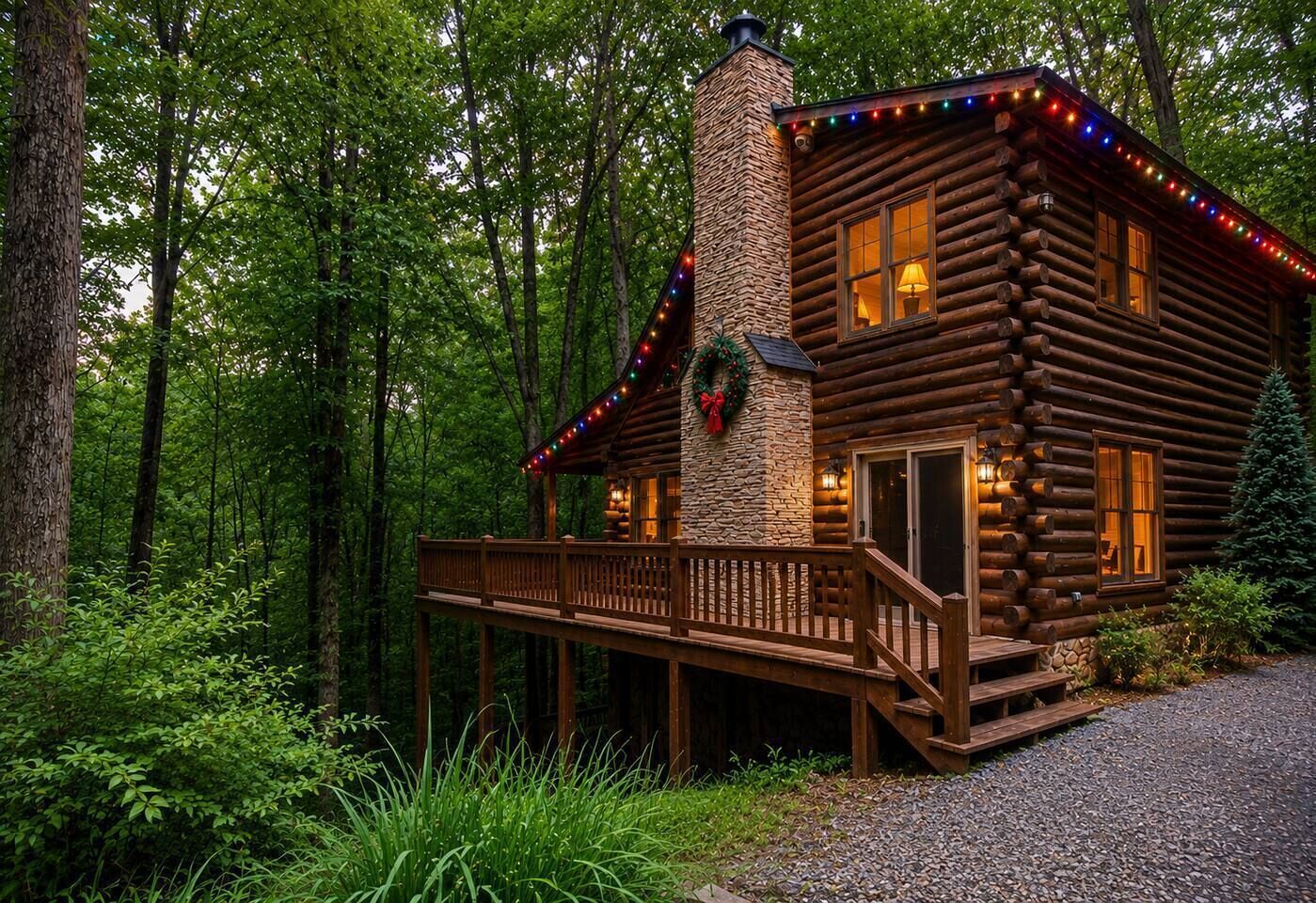 A log cabin with a stone chimney, a deck, and a wreath decoration.