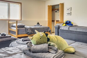 A room with a bunk bed, a small desk, and a dinosaur plush toy on the bed. - 6 Mi to Kenai Beach! Cozy Ocean-view Escape (Kenai)