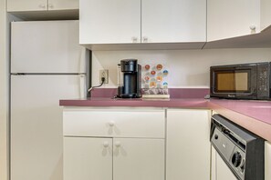 A kitchen with a microwave, coffee maker, and a set of colorful magnets on the counter. - 6 Mi to Kenai Beach! Cozy Ocean-view Escape (Kenai)