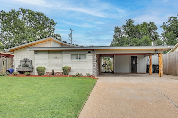 A single-story house with a garage, a front porch, and a well-maintained lawn.