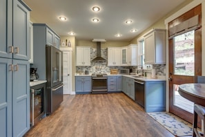 A kitchen with wooden flooring, built-in appliances, and a window with a view. - Spacious Glenwood Springs Getaway w/ Game Room! (Glenwood Springs)