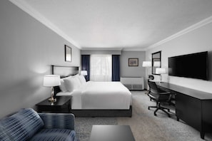 A hotel room with a bed, a desk, a chair, a TV, and a sofa. - Al Mubarakia Hotel Yanbu (Yanbu Al Bahr)