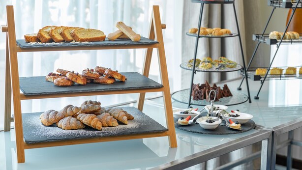 A multi-tiered display stand with various pastries and desserts. - Al Mubarakia Hotel Yanbu (Yanbu)