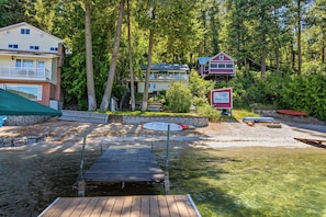 A lakeside property with a dock, a small boat, and a cabin. - Loon Lake Cabin w/ Private Beach & Dock (Loon Lake)