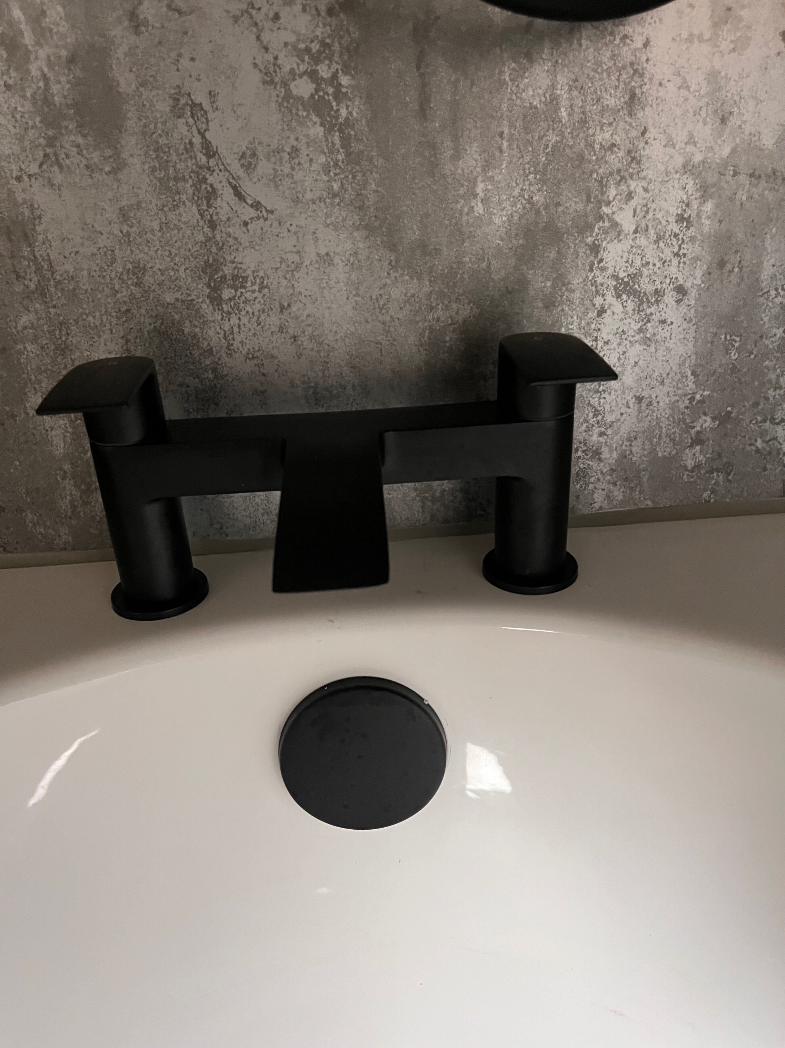 A bathroom sink with a modern faucet and a single basin.