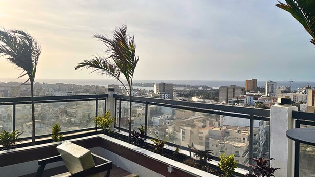 A rooftop terrace with a view of the cityscape, a seating area, and potted plants. - Standard "All-Comfort" Room in Dakar: Excellent Value for the Money (Dakar)