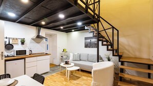 A compact living space with a kitchen, dining area, and a staircase. - Modern stylish apartment @ Superb central location (R) (Budapest)