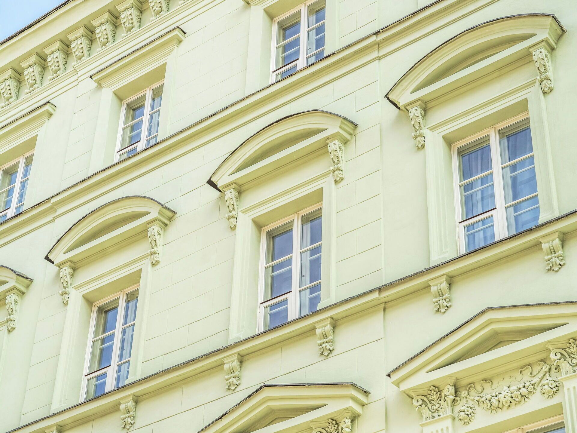 A building with multiple windows and decorative moldings.