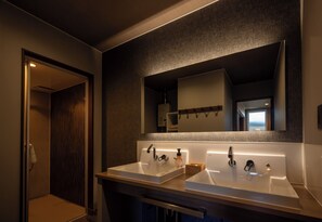 A modern bathroom with two sinks, a large mirror, and a shower. - hoshinohikarinoyado Biei (Biei)