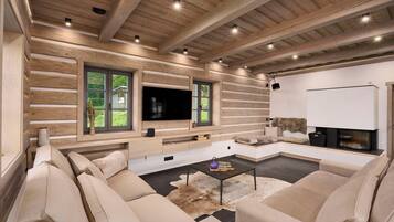 A modern living room with a large TV, wooden beams, and a fireplace.