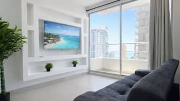 Deluxe Apartment, 3 Bedrooms, Pool Access, Sea View | Living area | 55-inch Smart TV with cable channels, Netflix, streaming services