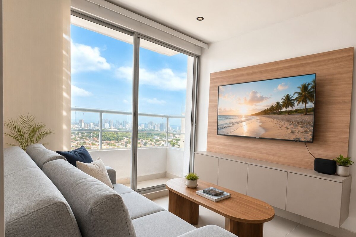 Una sala de estar moderna con un sofá, una mesa de centro y un televisor montado en la pared.