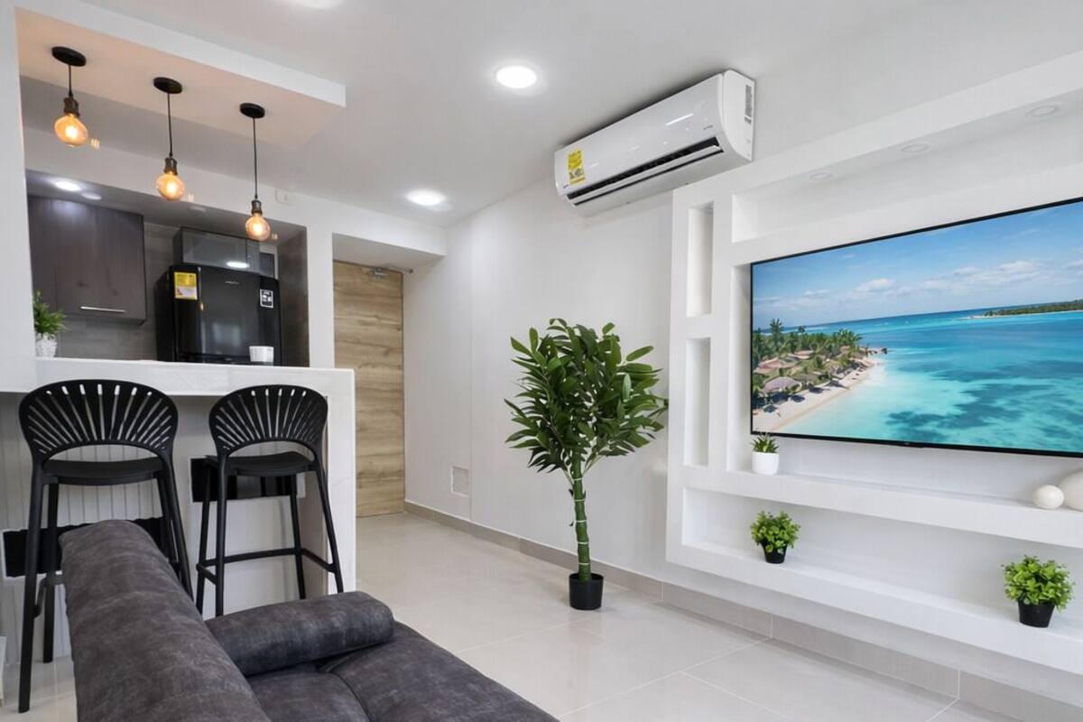 Deluxe Apartment, 3 Bedrooms, Pool Access, Sea View | Living area | 55-inch Smart TV with cable channels, Netflix, streaming services
