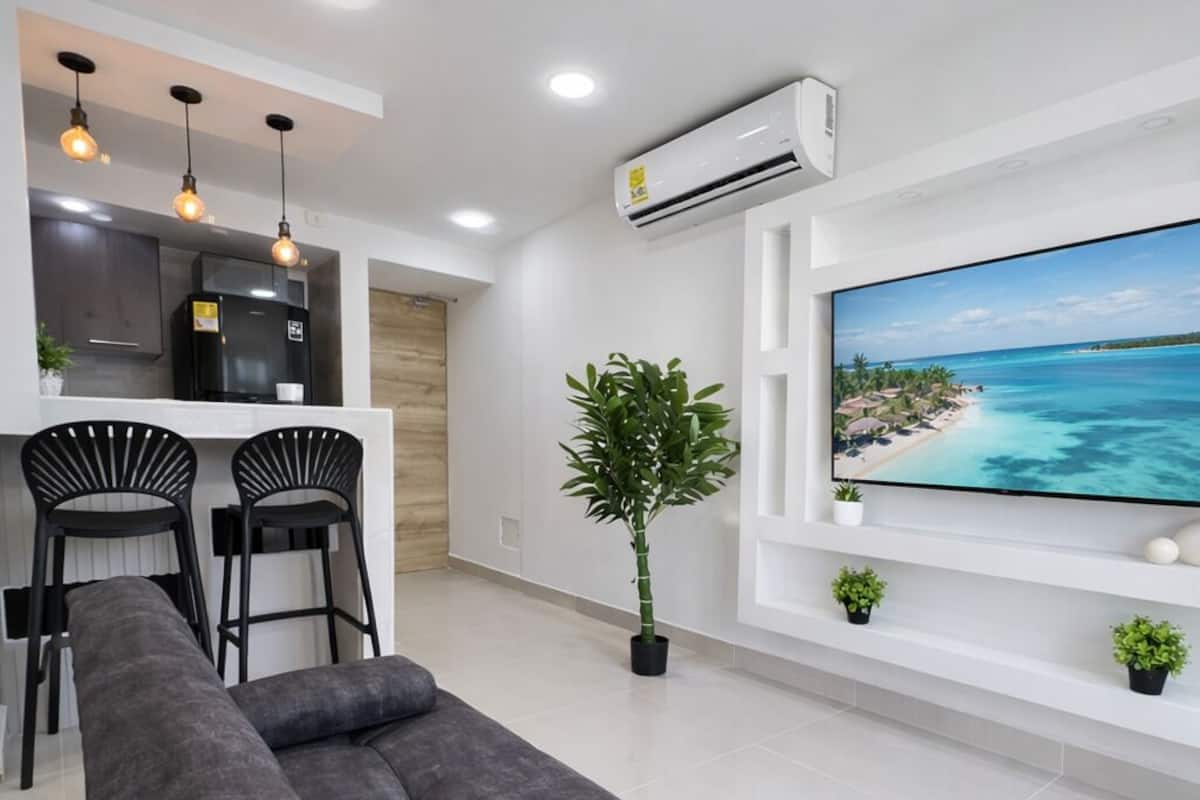 Deluxe Apartment, 3 Bedrooms, Pool Access, Sea View | Living area | 55-inch Smart TV with cable channels, Netflix, streaming services