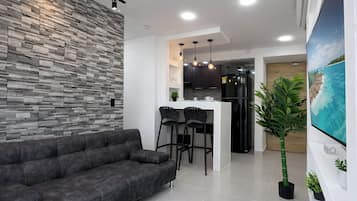 Deluxe Apartment, 3 Bedrooms, Pool Access, Sea View | Living area | 55-inch Smart TV with cable channels, Netflix, streaming services
