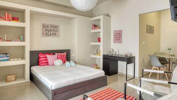 A modern bedroom with a bed, bedside tables, a desk, and a chair.