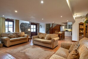 A spacious living area with two sofas, a dining table, and a kitchen in the background. - Roost, Quinceborough Farm (Widemouth Bay)