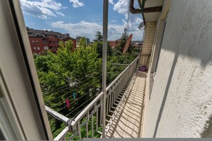 A balcony with a view of buildings and trees. - KVR Signature Duplex | City Center (Prishtinë)