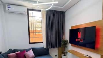 Deluxe Studio, City View | Living area | 45-inch Smart TV with digital channels
