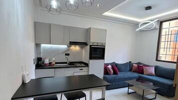 Deluxe Studio, City View | Living area | 45-inch Smart TV with digital channels