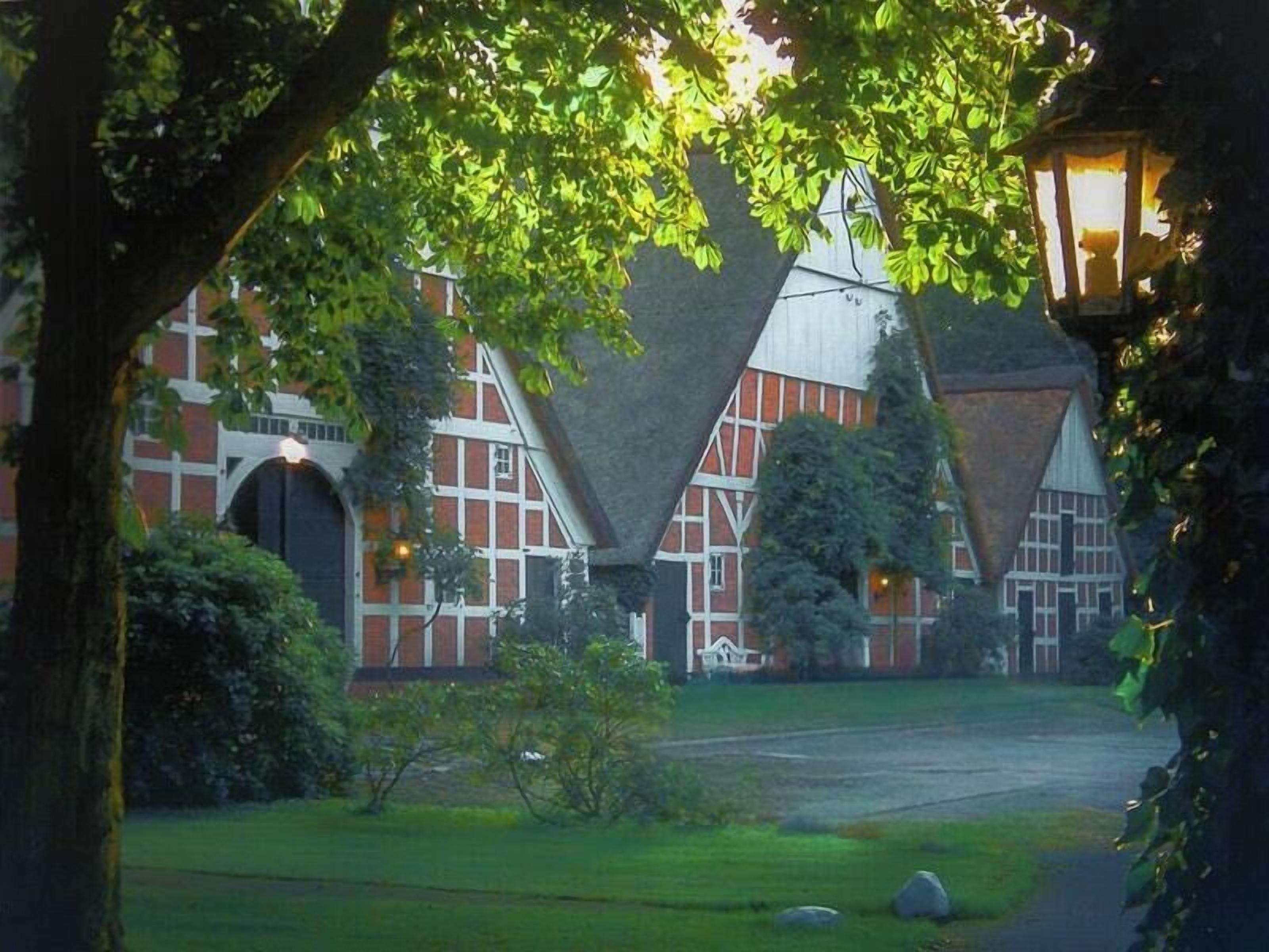 A traditional building with a symmetrical facade, large windows, and a central entrance.