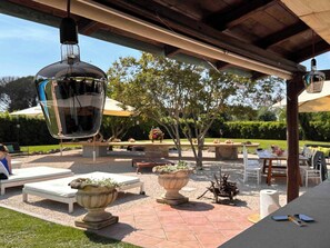 An outdoor patio area with lounge chairs, planters, and a pergola structure. - Villa Elena - Luxury Mansion in Rome (Rome)