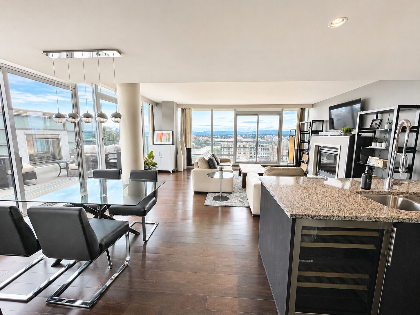 A modern apartment with a dining area, living room, and kitchen.
