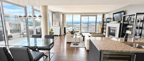 A modern apartment with a dining area, living room, and kitchen.