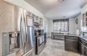 A modern kitchen with stainless steel appliances, a built-in oven, and a water dispenser. - Near Dining, Shopping, Parks! Tranquil Fox Trails (Memphis)